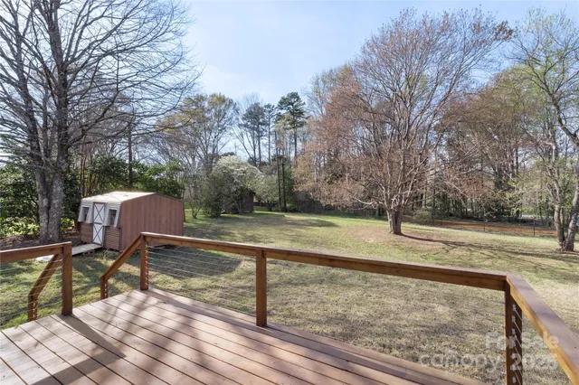a view of a yard with wooden fence
