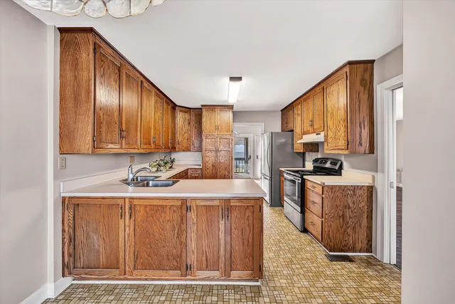 a kitchen with a sink cabinets and appliances