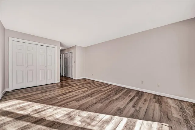 a view of a room with wooden floor