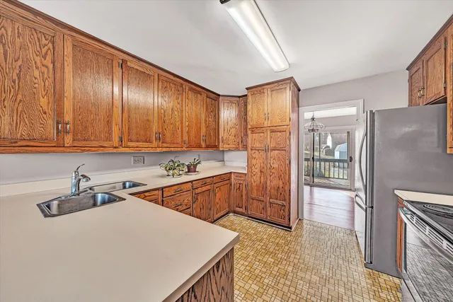 a kitchen that has a sink a stove and a refrigerator
