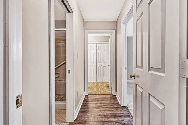 a view of a hallway with a wooden door