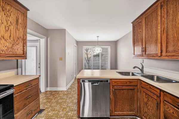 a kitchen with stainless steel appliances granite countertop a sink stove and cabinets