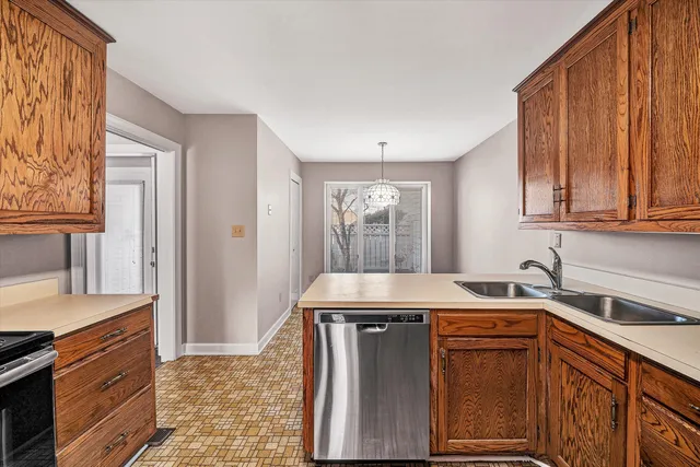 a kitchen with stainless steel appliances granite countertop a sink stove and cabinets
