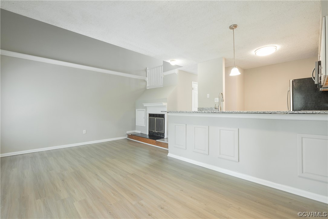 2675 Chancer Drive Henrico, VA 23233 - Photo 23 of 49 an empty room with wooden floor and kitchen view
