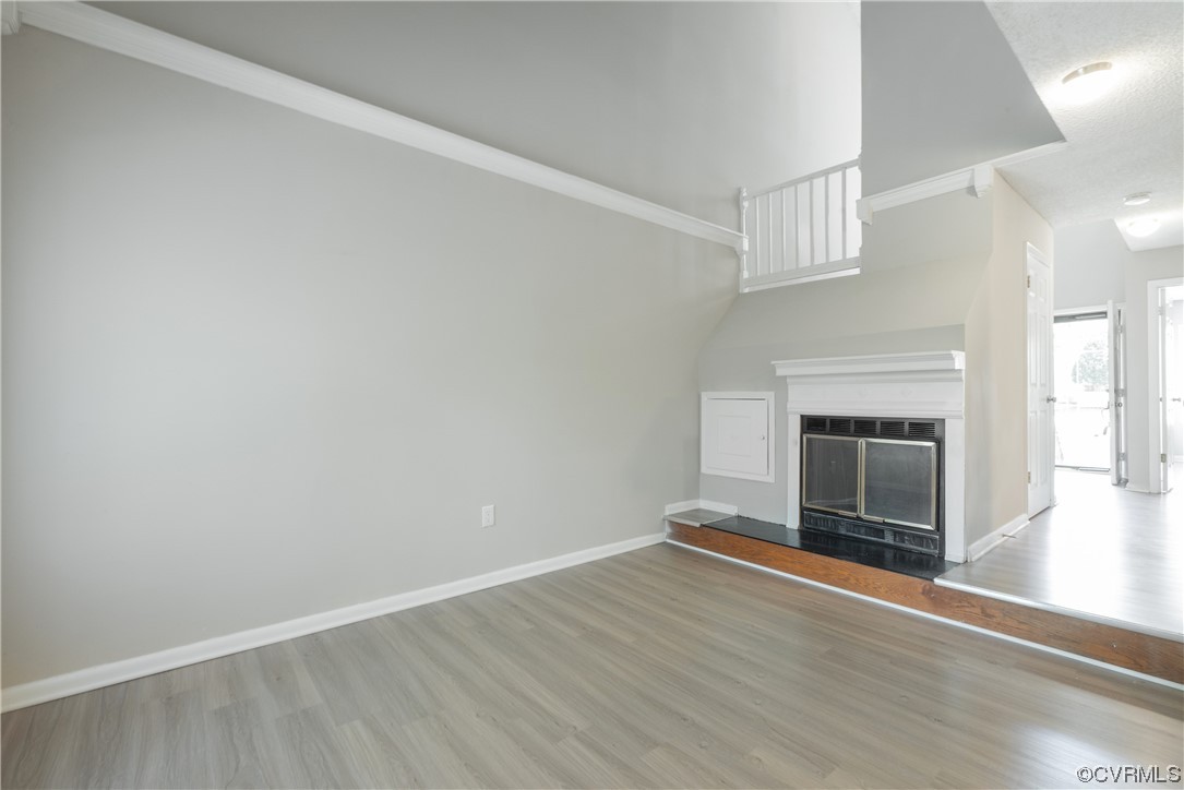 2675 Chancer Drive Henrico, VA 23233 - Photo 25 of 49 an empty room with wooden floor fireplace and windows