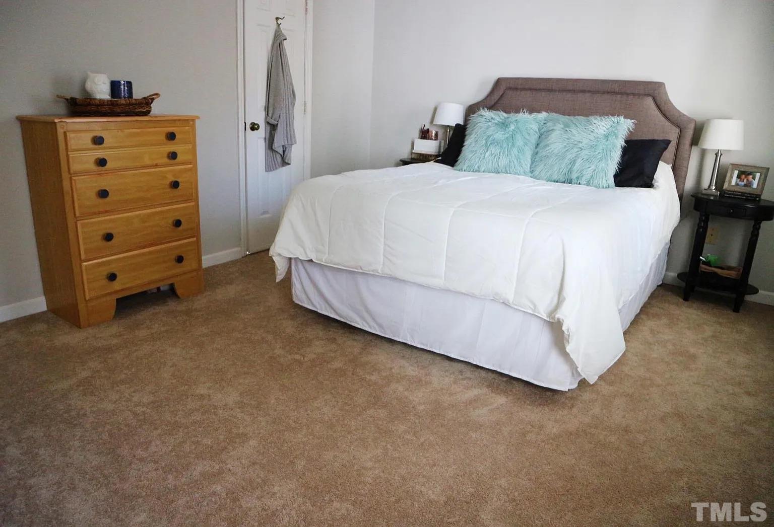 4626 Townesbury Lane Raleigh, NC 27612 - Photo 6 of 8 a bedroom with a bed and a tv