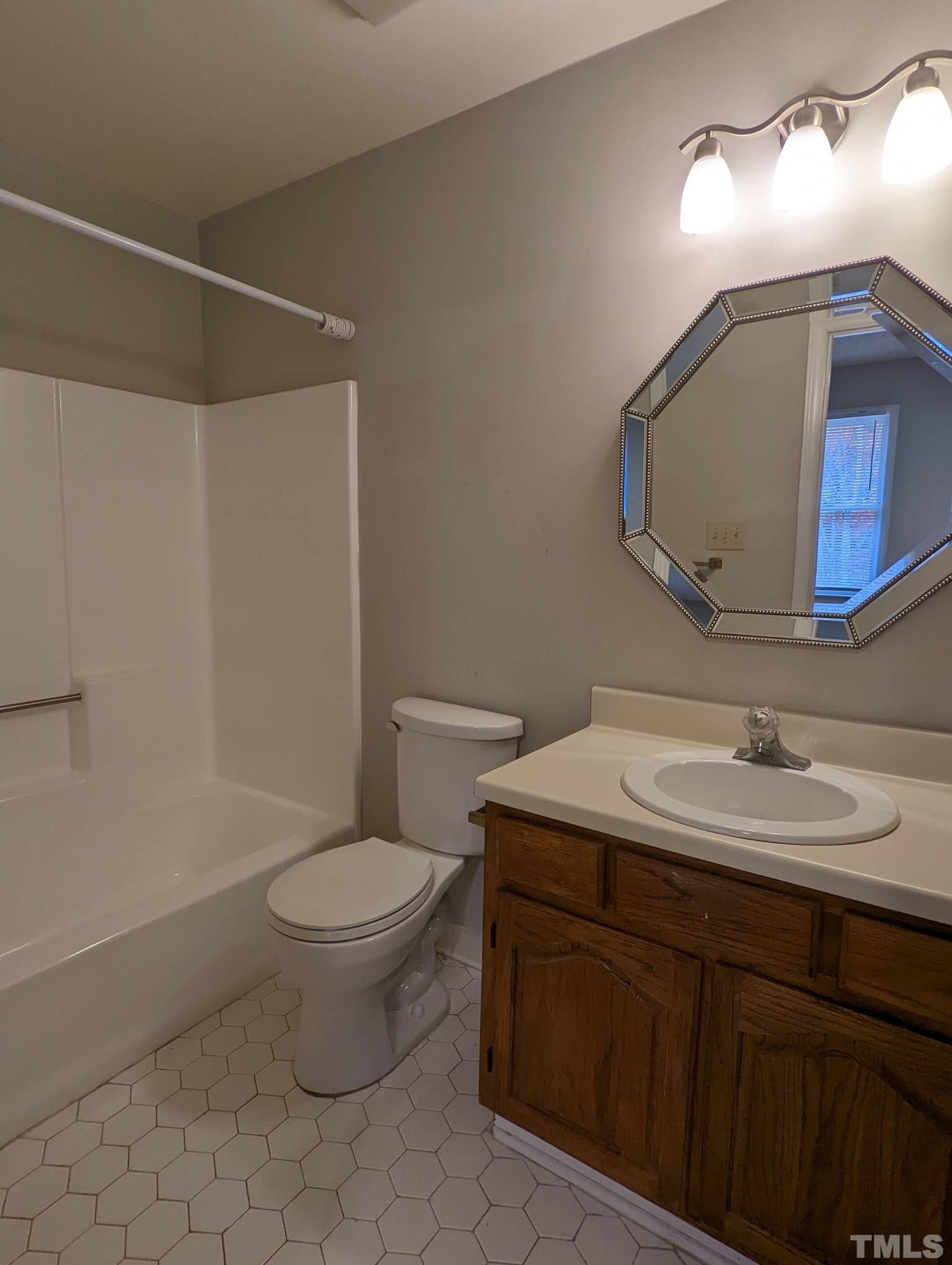 4626 Townesbury Lane Raleigh, NC 27612 - Photo 7 of 8 a bathroom with a toilet sink and mirror