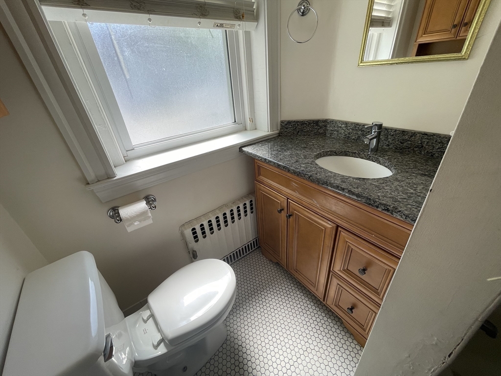 96 St Paul Street, Unit 2 Brookline, MA 02446 - Photo 12 of 14 a bathroom with a granite countertop sink and a mirror