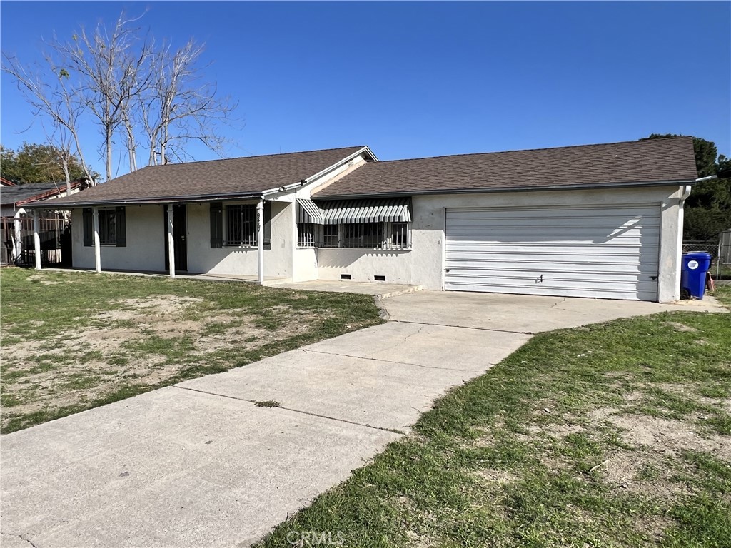 9467 Palm Lane Fontana, CA 92335 - Photo 1 of 13 a front view of a house with a yard and garage