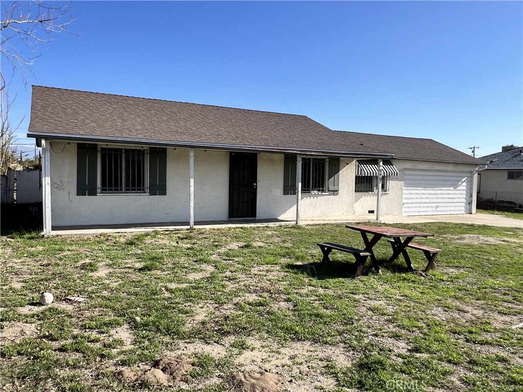 9467 Palm Lane Fontana, CA 92335 - Photo 2 of 13 a front view of a house with garden