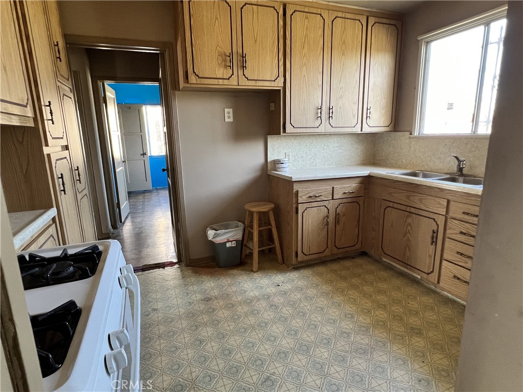 9467 Palm Lane Fontana, CA 92335 - Photo 7 of 13 a kitchen with stainless steel appliances granite countertop a refrigerator and a stove top oven