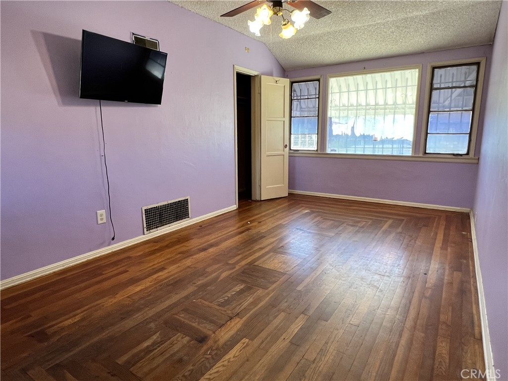 9467 Palm Lane Fontana, CA 92335 - Photo 9 of 13 a view of an empty room with wooden floor and a window