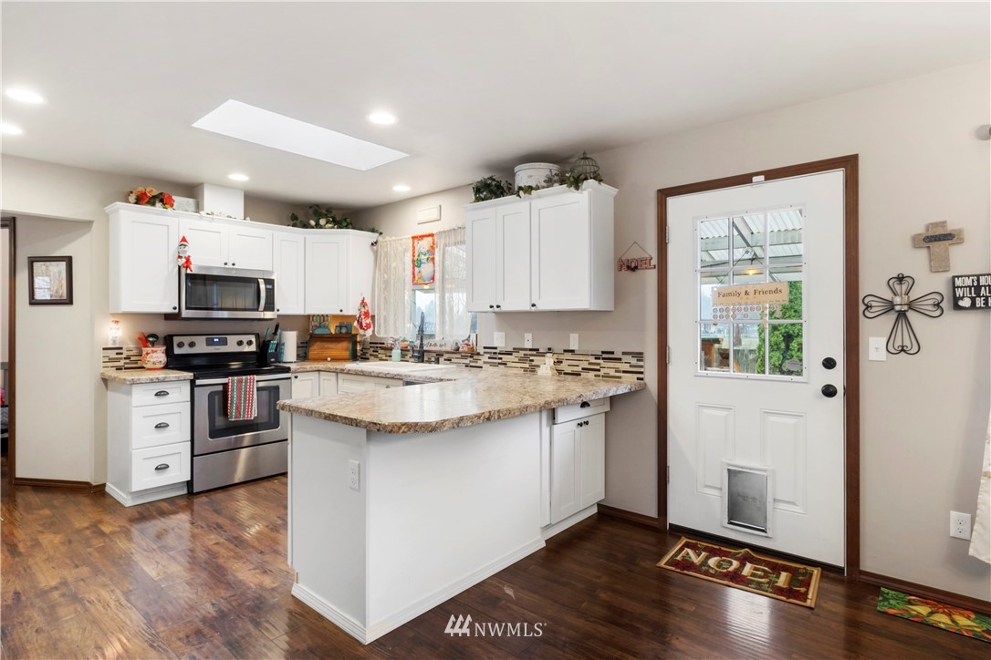 17936 Jordan Street Southwest Rochester, WA 98579 - Photo 8 of 28 a kitchen with stainless steel appliances a stove a sink and a refrigerator