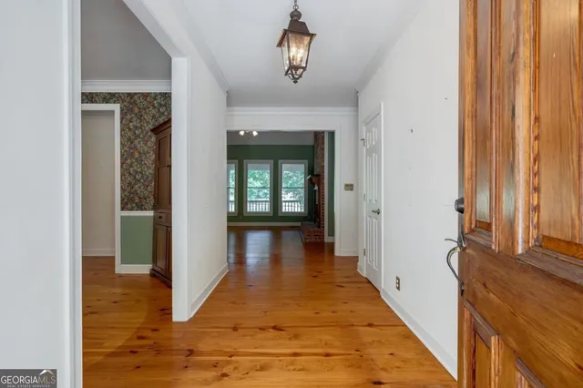 a living room with a fireplace and a wooden floor