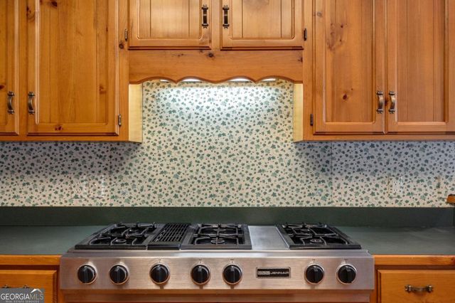 a kitchen that has a sink a stove and a wooden floor