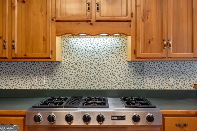 a kitchen that has a sink a stove and a wooden floor
