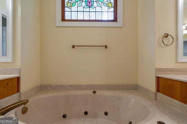 a living room with furniture a fireplace and a chandelier