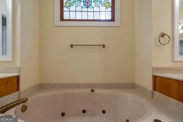 a living room with furniture a fireplace and a chandelier