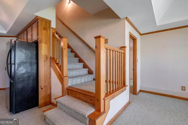 a view of empty room with chandelier fan and fire place