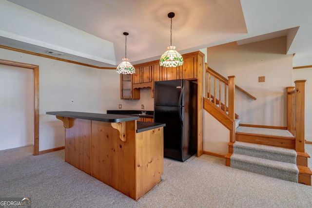 a view of a house with backyard and tree