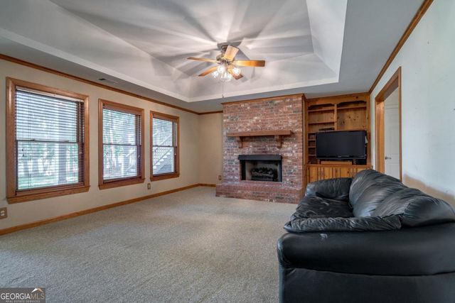 a view of a lake with couches and wooden floor