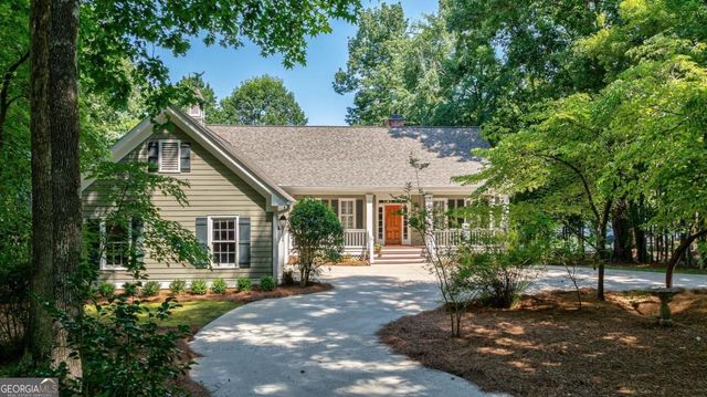 a view of a house with a small yard and wooden fence