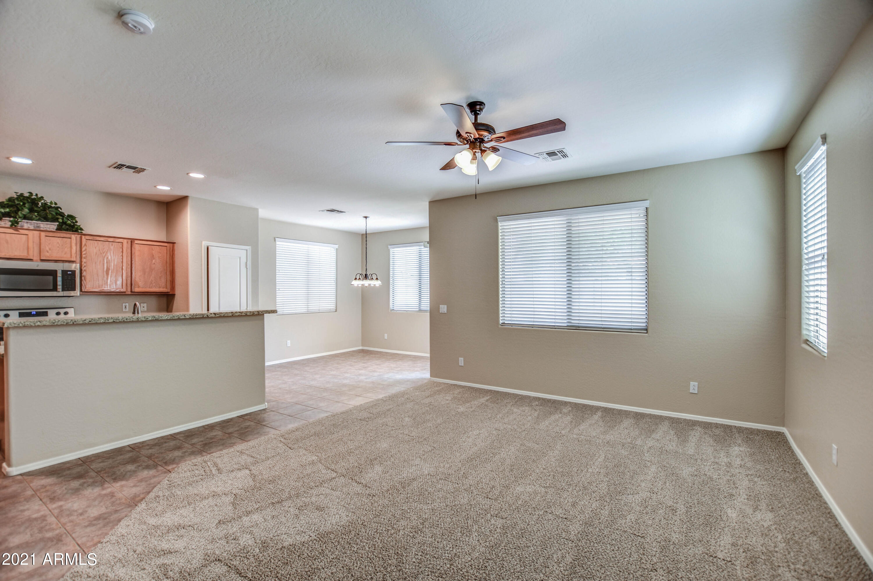 3787 East Chickadee Road Gilbert, AZ 85297 - Photo 12 of 41 a view of an empty room with a kitchen stove and a window