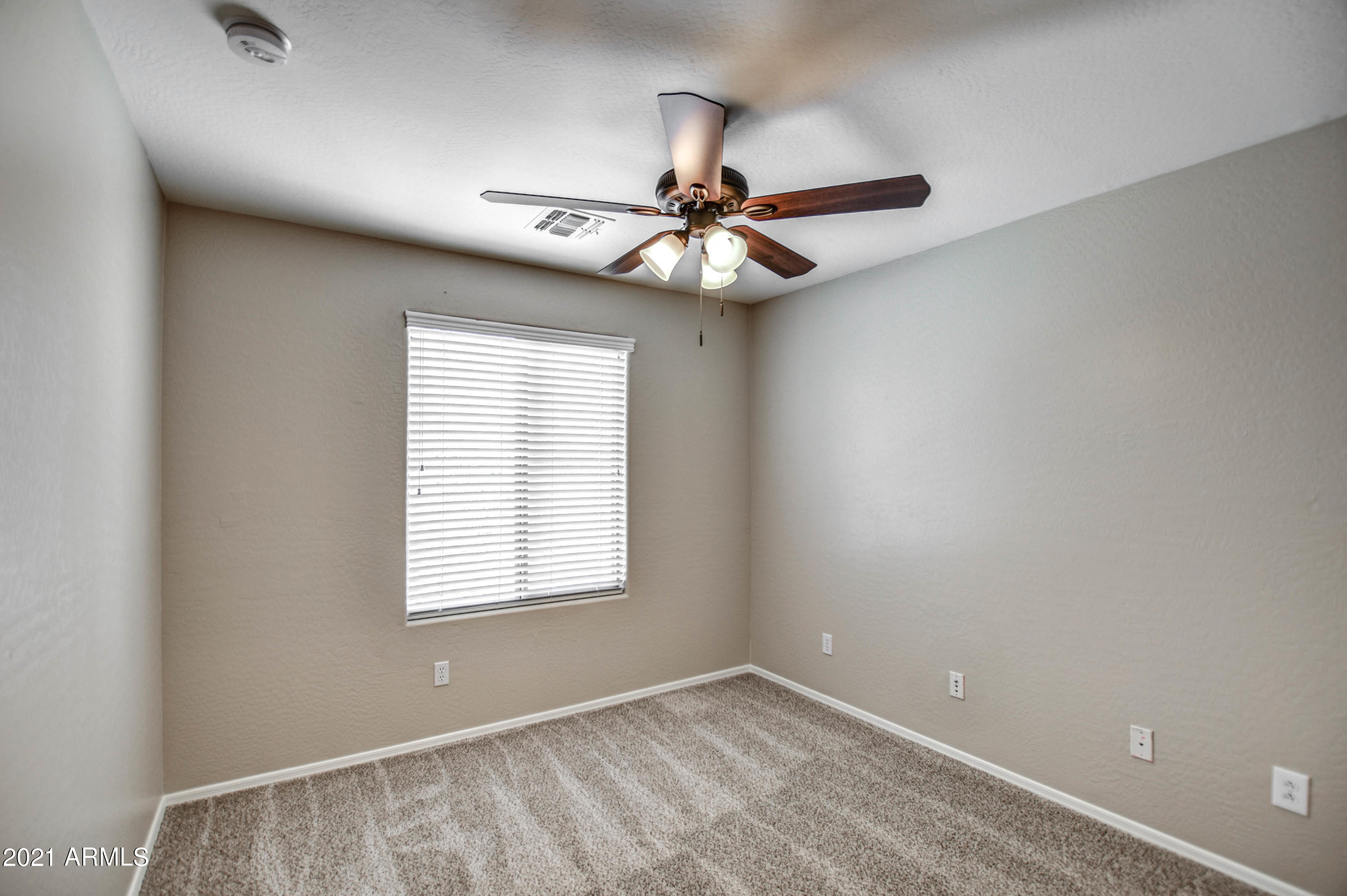 3787 East Chickadee Road Gilbert, AZ 85297 - Photo 20 of 41 an empty room with windows and fan