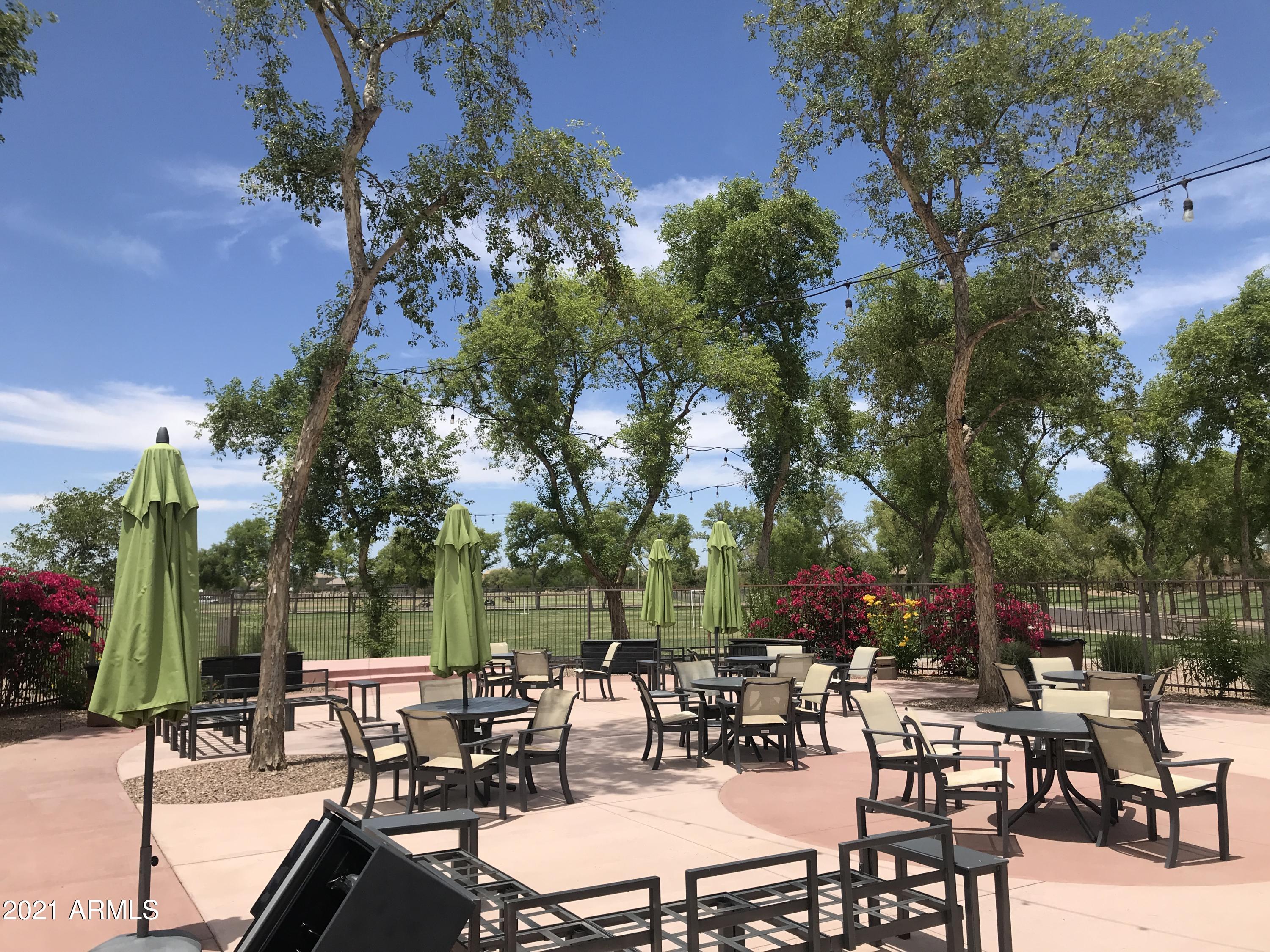 3787 East Chickadee Road Gilbert, AZ 85297 - Photo 35 of 41 a view of a tables and chairs under an umbrella