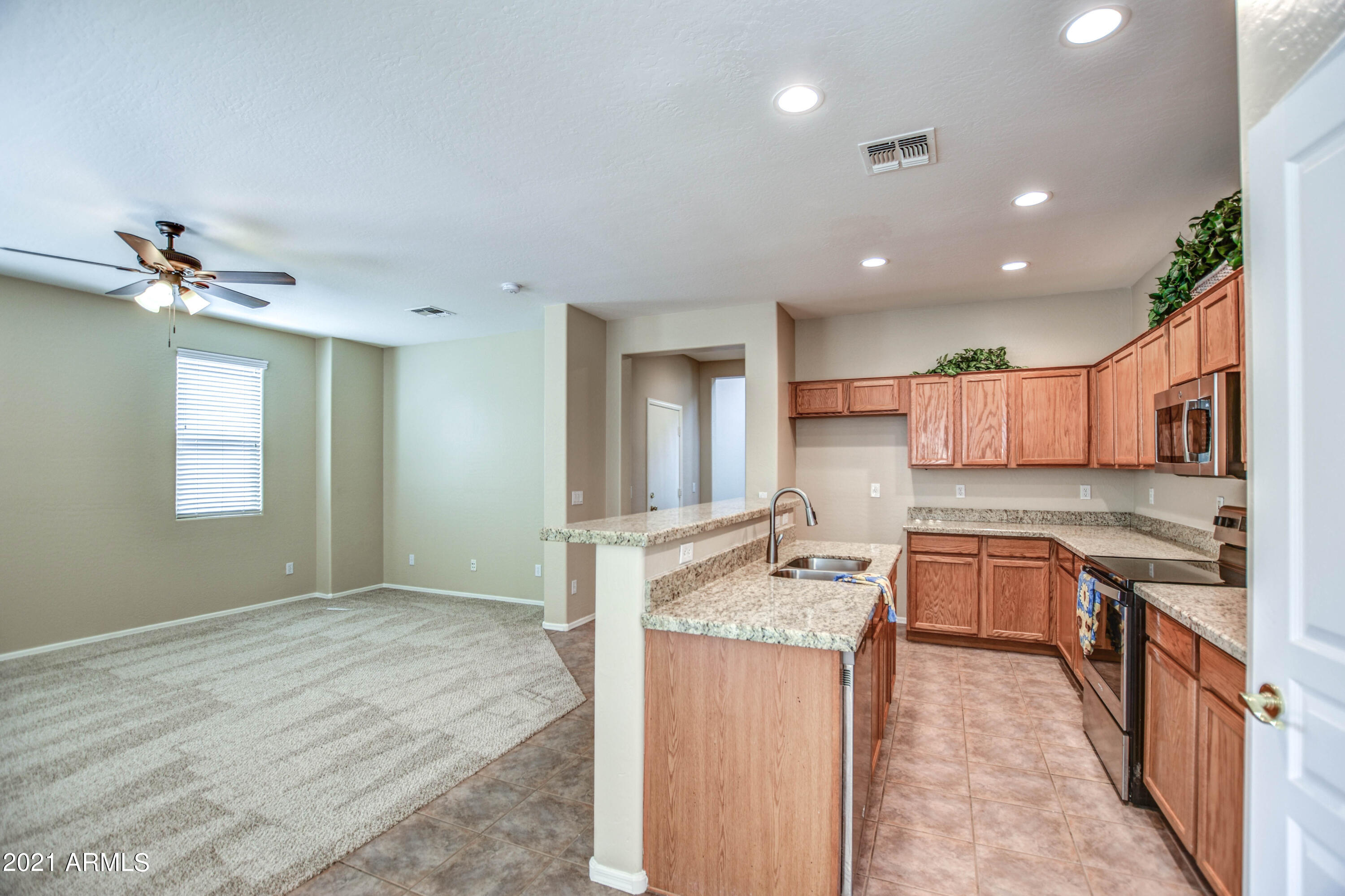 3787 East Chickadee Road Gilbert, AZ 85297 - Photo 4 of 41 a kitchen with a sink stove and cabinets