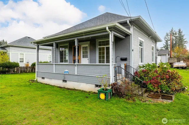 a front view of a house with a garden and yard