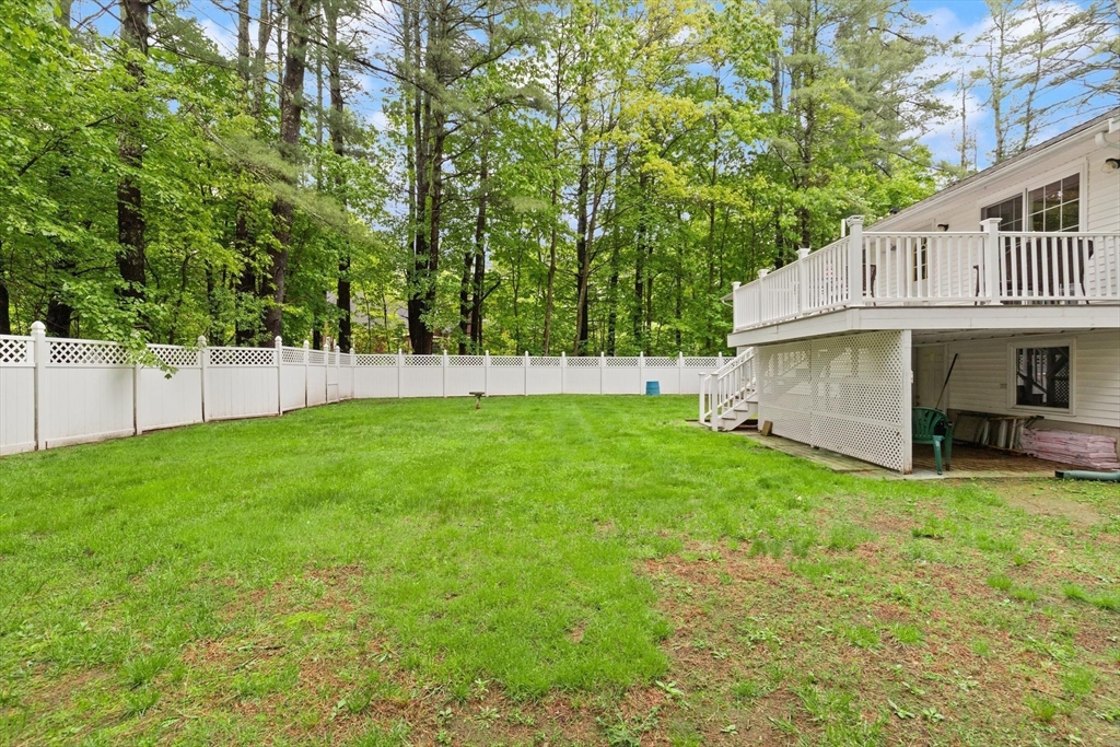 901 Haverhill Street Rowley, MA 01969 - Photo 41 of 42 a view of a yard with a house and a large tree