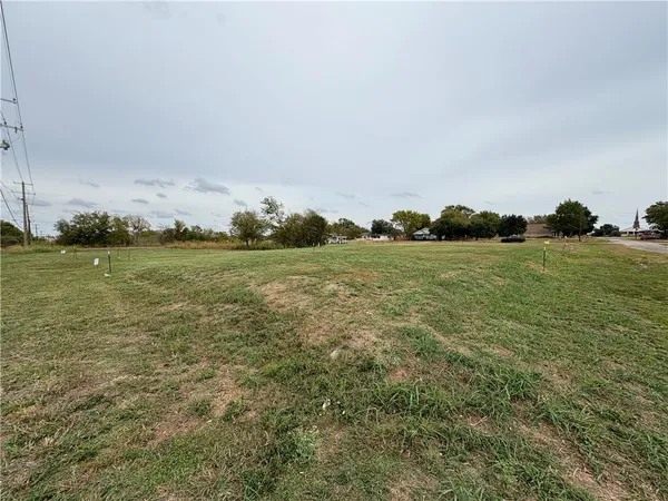 a view of a field with an ocean