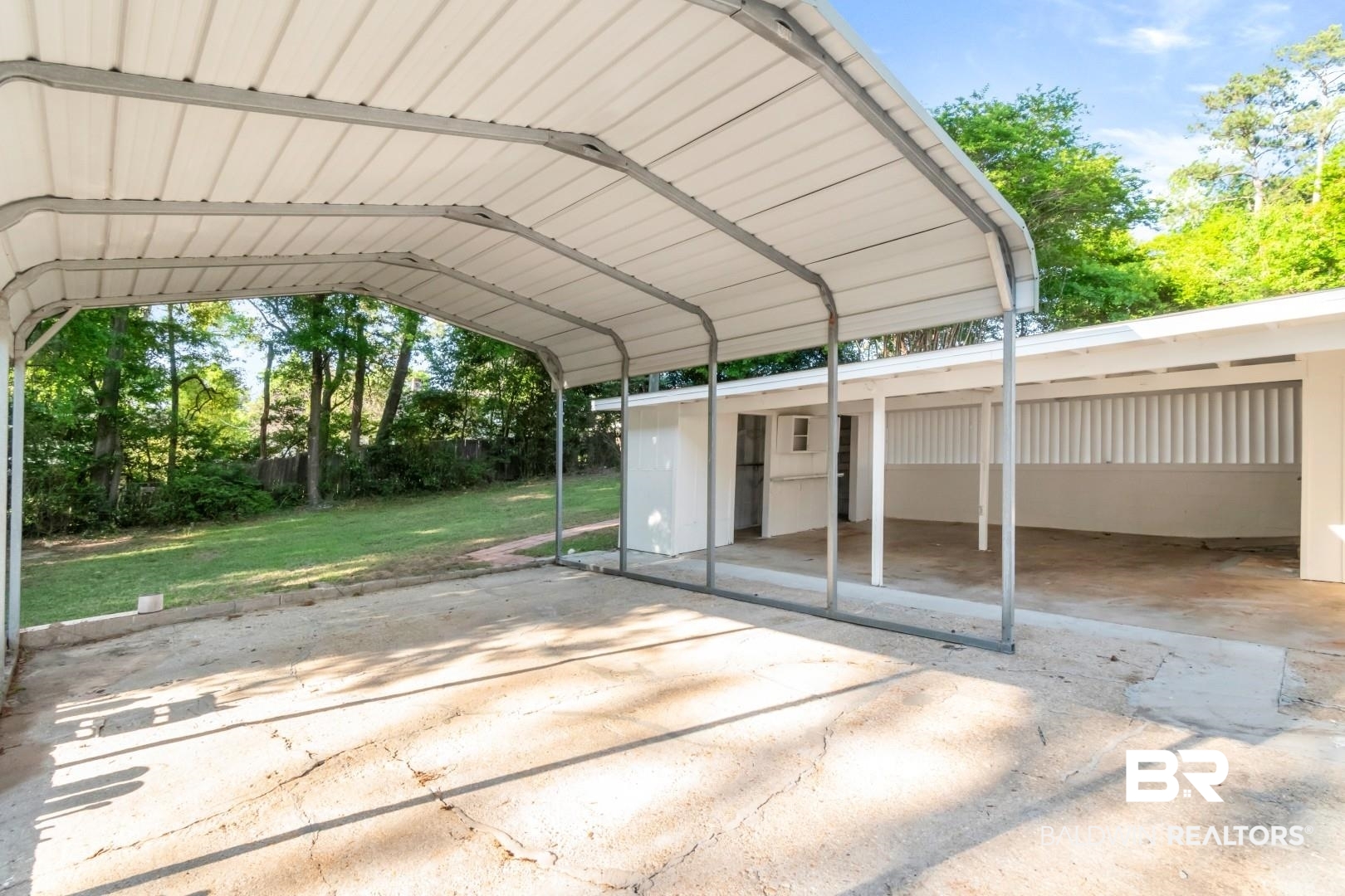 115 Pineridge Road Daphne, AL 36526 - Photo 32 of 34 View of parking / parking lot with a carport