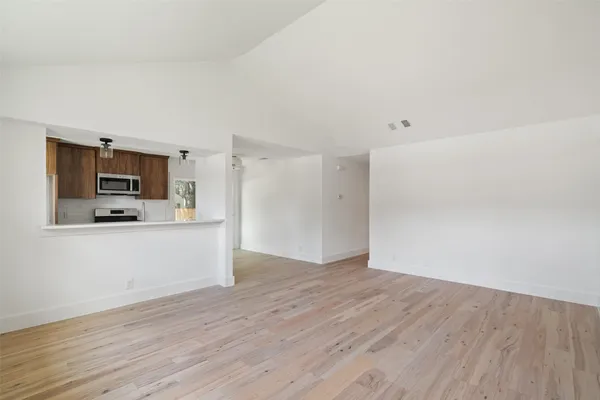 a view of a kitchen with wooden floor