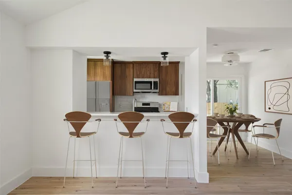 a view of a dining room with furniture and wooden floor