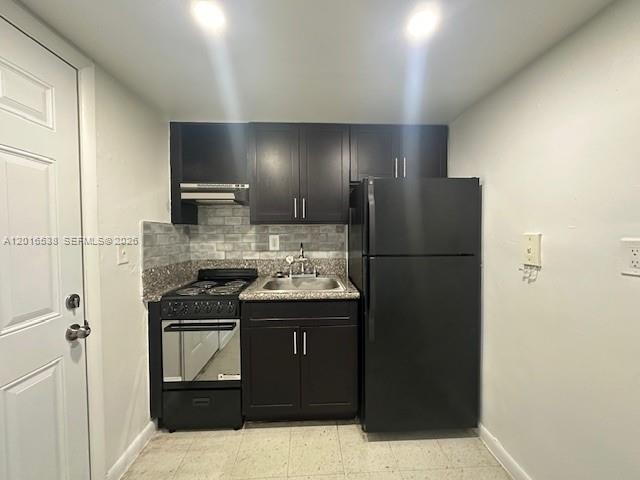 1400 Douglas Road, Unit 14 Coral Gables, FL 33134 - Photo 8 of 19 a kitchen with a refrigerator and a sink