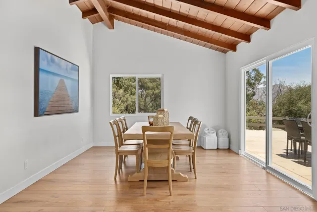 a dining room with furniture a chandelier and wooden floor