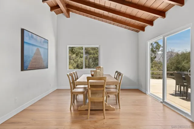 a dining room with furniture a chandelier and wooden floor