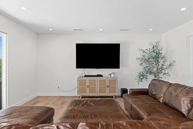 a living room with a flat screen tv and a couch