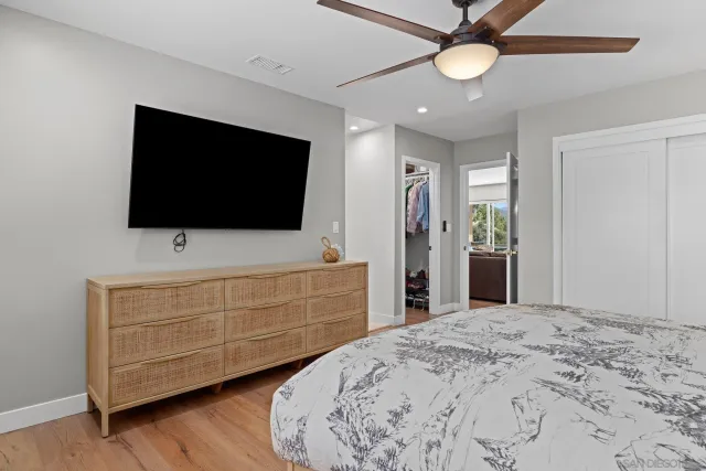 a bedroom with a bed and a flat screen tv