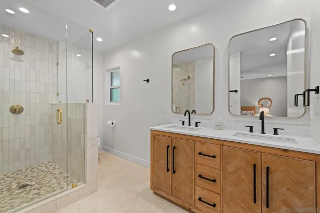a bathroom with double sink and a mirror
