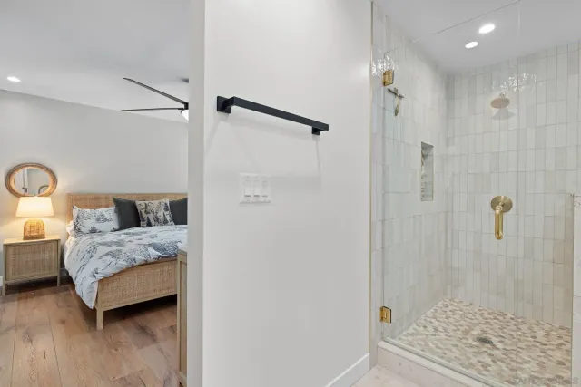 a spacious bedroom with a bed and a shower