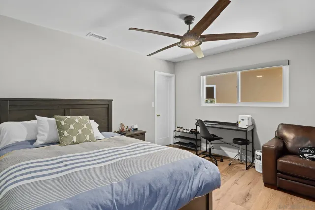a bedroom with bed and a chandelier