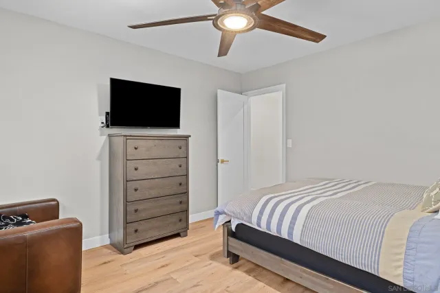 a bedroom with a bed and a television