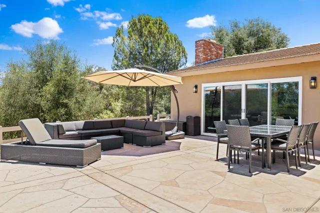 a view of a patio with table and chairs potted plants with wooden fence