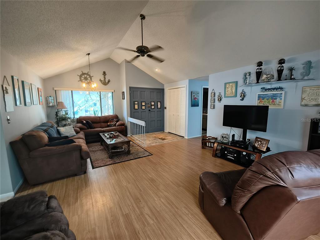 7519 Clanton Trail Hudson, FL 34667 - Photo 13 of 83 a living room with furniture a window and a flat screen tv