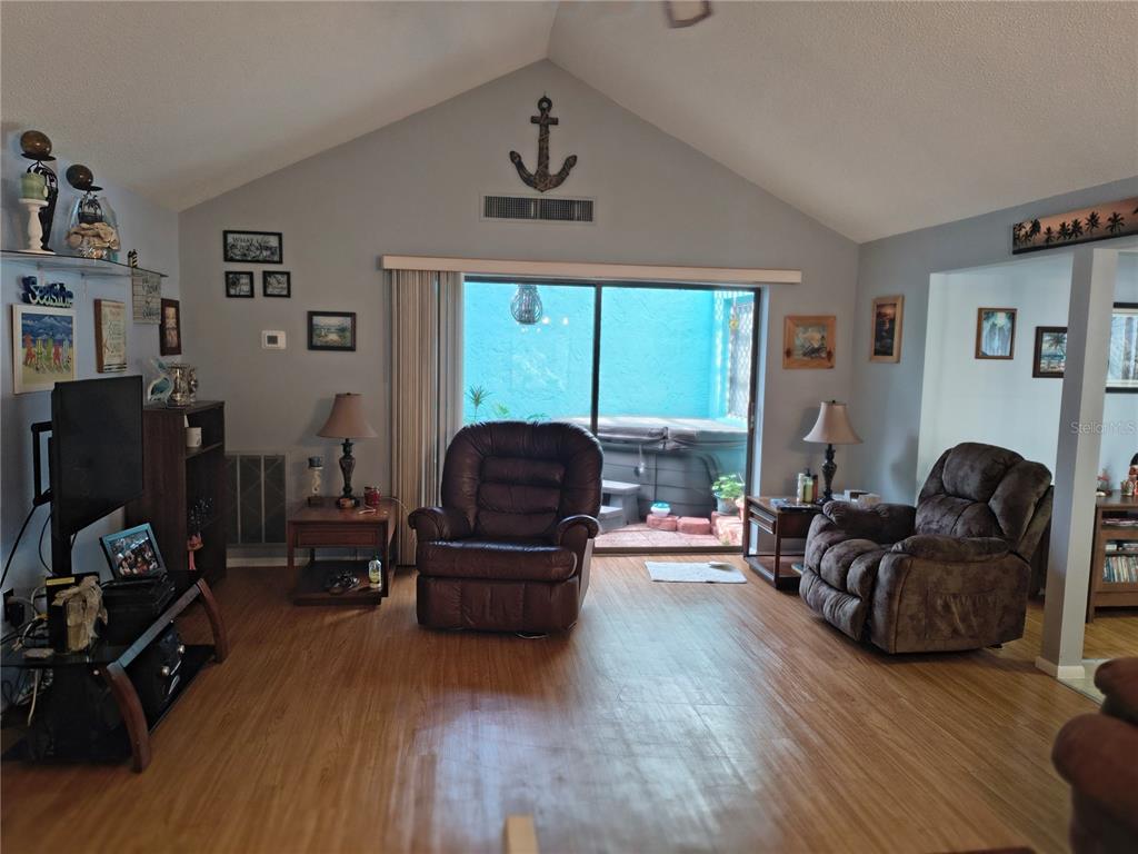 7519 Clanton Trail Hudson, FL 34667 - Photo 15 of 83 a living room with furniture fireplace and a window