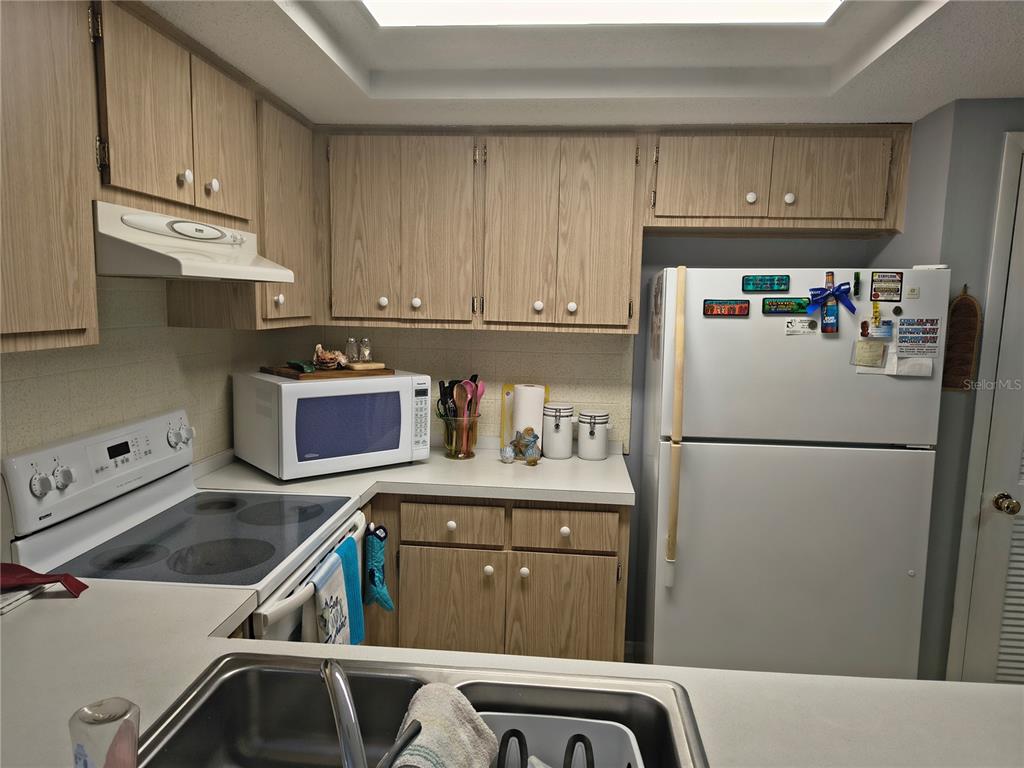 7519 Clanton Trail Hudson, FL 34667 - Photo 22 of 83 a kitchen with a refrigerator a stove a sink and cabinets