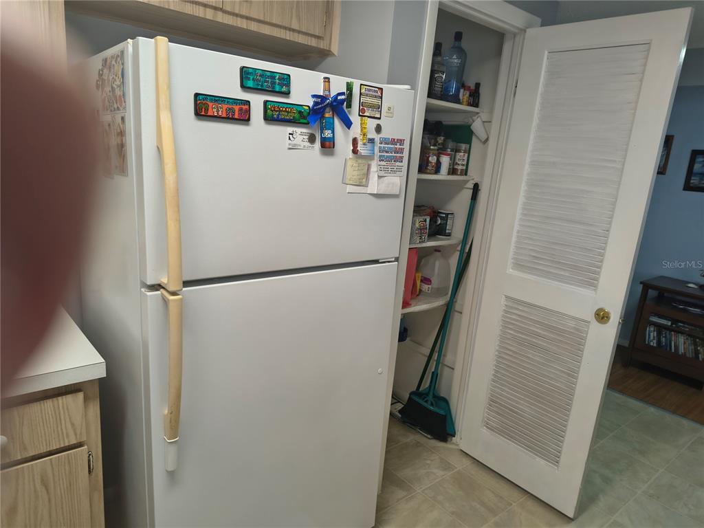 7519 Clanton Trail Hudson, FL 34667 - Photo 23 of 83 a white refrigerator freezer and a stove sitting inside of a kitchen